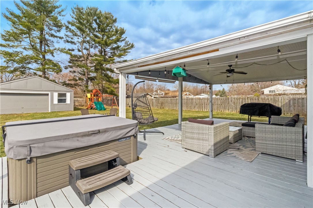 5900 Lear Nagle Road North Ridgeville, OH 44039 - Photo 30 of 35 Wooden deck featuring ceiling fan, a hot tub, a fenced backyard, and a playground