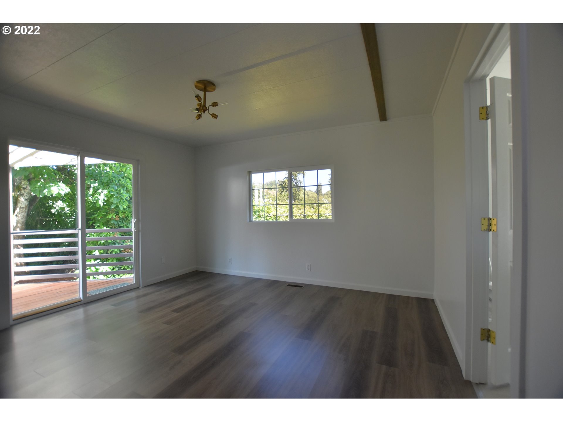 1629 Harbor Drive Springfield, OR 97477 - Photo 19 of 32 a view of an empty room with wooden floor and a window