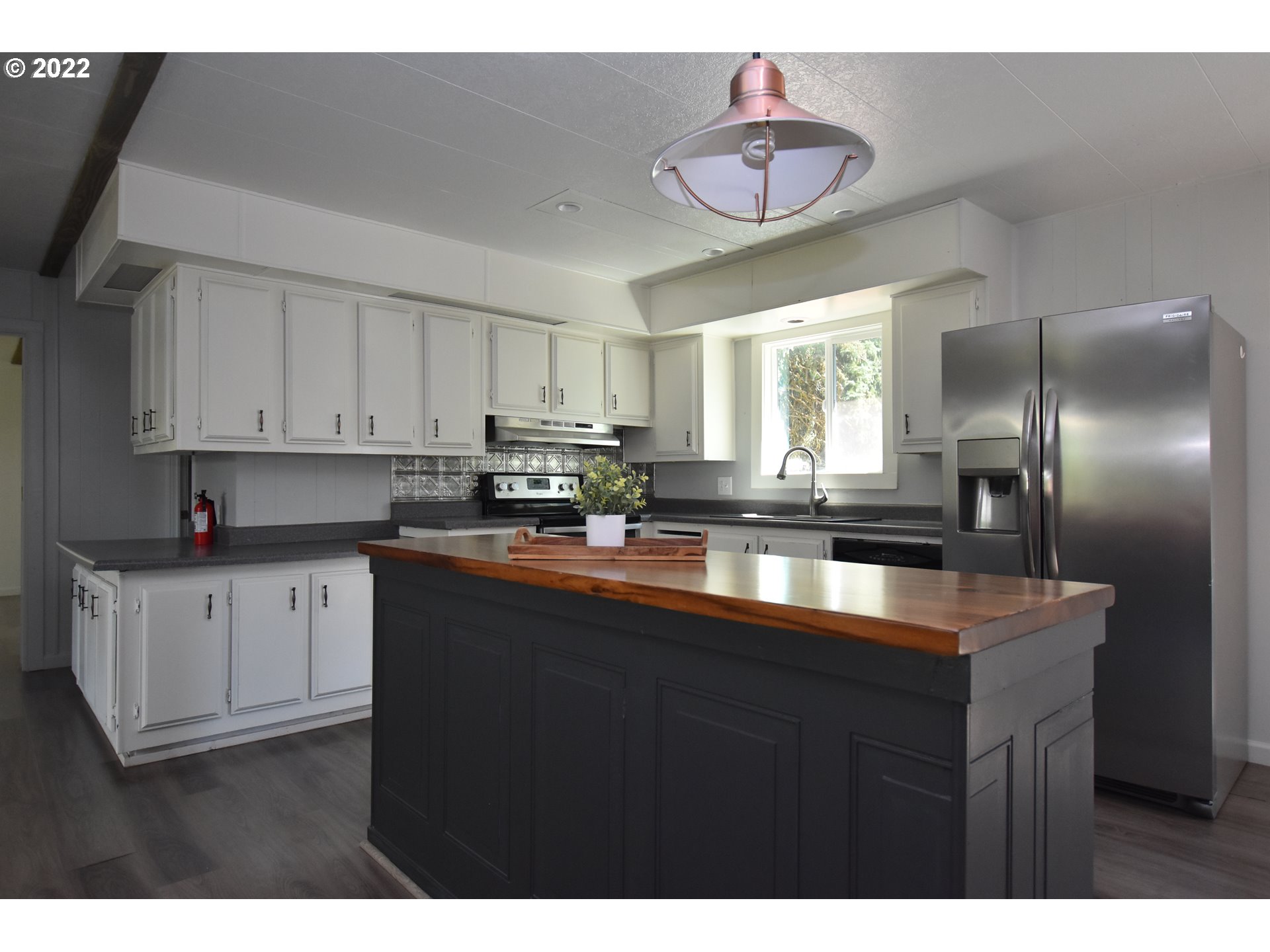 1629 Harbor Drive Springfield, OR 97477 - Photo 6 of 32 a kitchen with stainless steel appliances granite countertop a sink a stove cabinets dining table and chairs