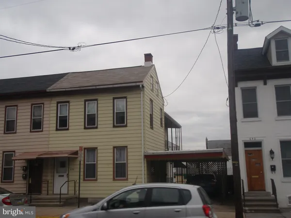 a front view of a house with parking space