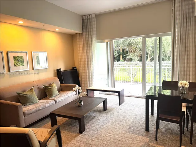 a living room with furniture and large windows