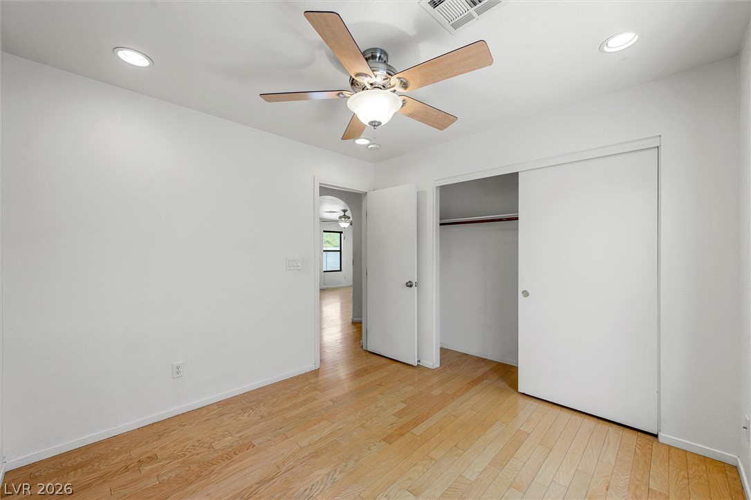 6762 Arapaho Ranch Las Vegas, NV 89148 - Photo 19 of 27 Bright hardwood floors and a ceiling fan create a comfortable atmosphere in this inviting room.