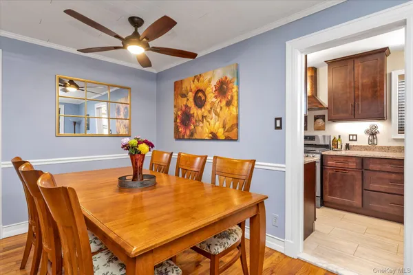 a dining room with a table chairs and a kitchen view