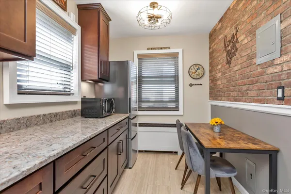a kitchen with a table chairs and a window