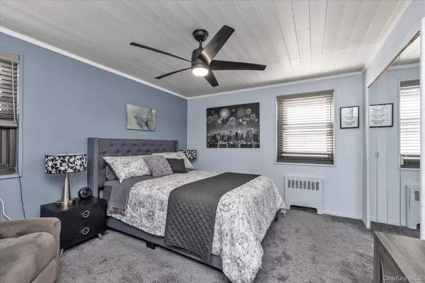 a bedroom with a bed and a ceiling fan