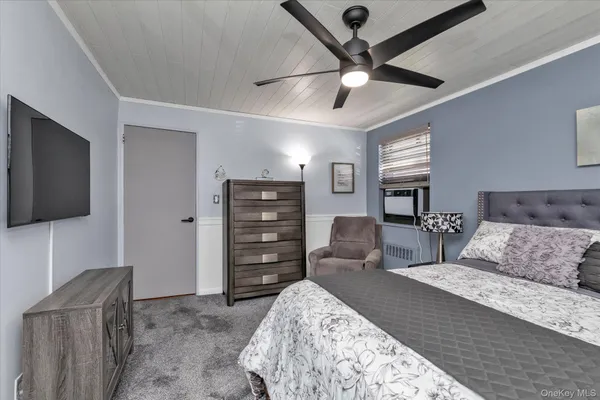 a bedroom with a bed and a flat screen television