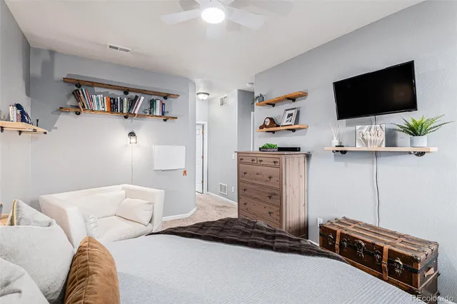a bedroom with a bed and flat screen tv
