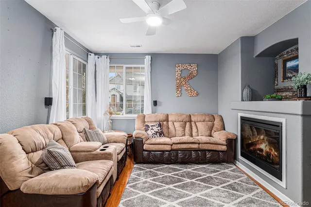 a living room with furniture and a fireplace