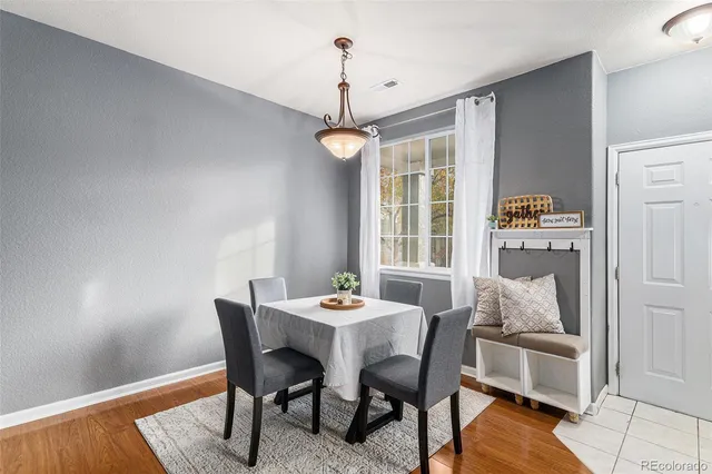 a dining room with furniture and window