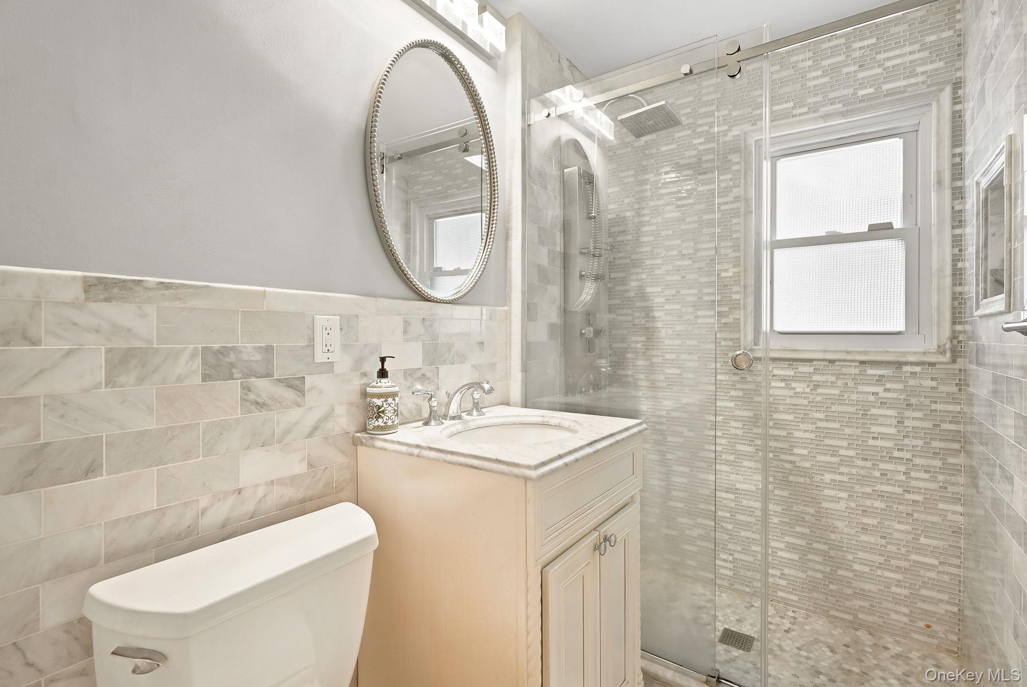 1 Sheridan Road Scarsdale, NY 10583 - Photo 16 of 40 First floor hall bath with shower in sophisticated neutral tones