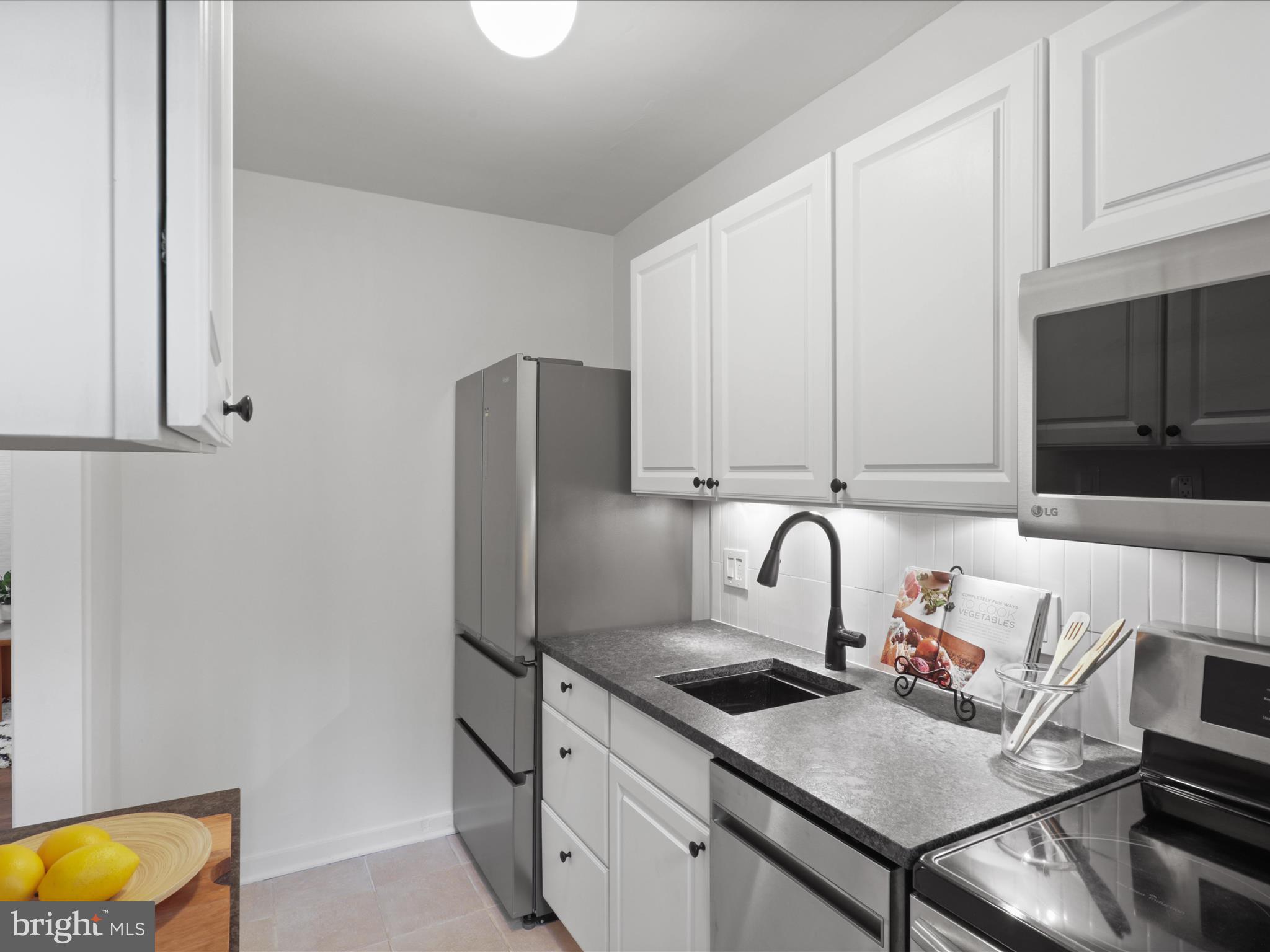 9 East Glebe Road, Unit C Alexandria, VA 22305 - Photo 12 of 38 a kitchen with stainless steel appliances granite countertop a stove top oven a sink and dishwasher