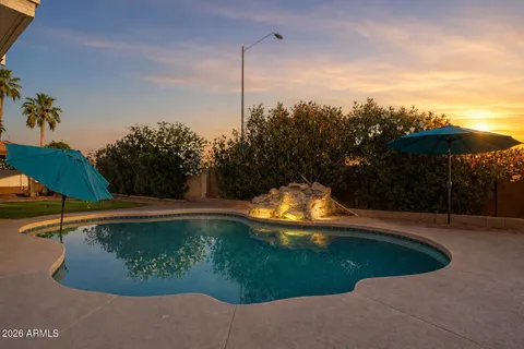 a view of a swimming pool with an outdoor space and seating area