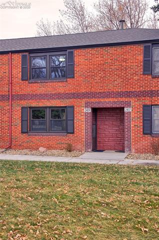 2419 Paseo Road Colorado Springs, CO 80907 - Photo 10 of 23 The front door is located in a covered alcove sheltered from rain & snow