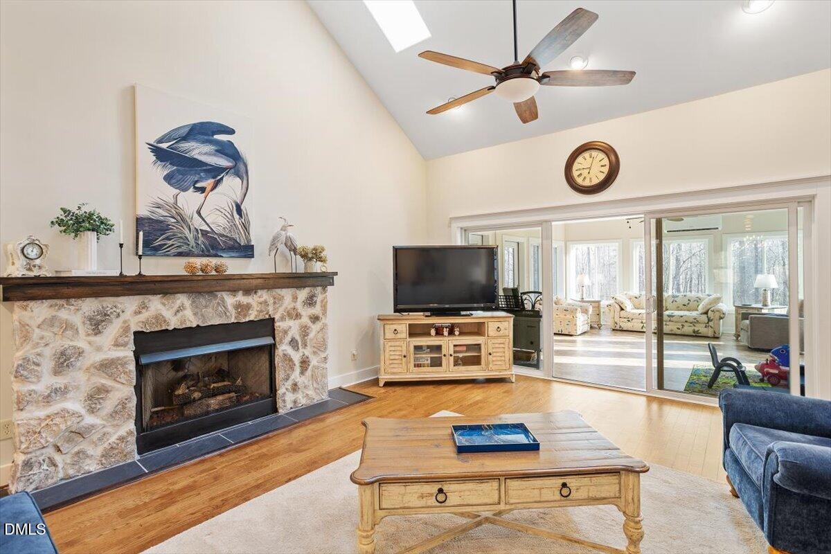 31 River View Court Timberlake, NC 27583 - Photo 13 of 44 a living room with furniture a fireplace and a flat screen tv