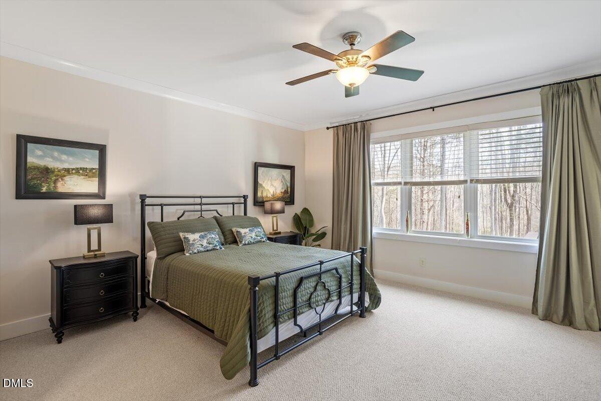 31 River View Court Timberlake, NC 27583 - Photo 23 of 44 a bedroom with a bed chandelier and a window