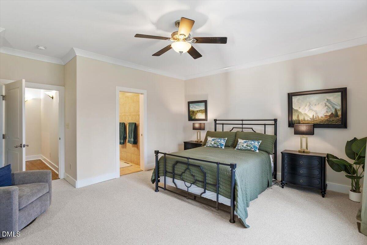 31 River View Court Timberlake, NC 27583 - Photo 24 of 44 a bedroom with a bed and a chandelier