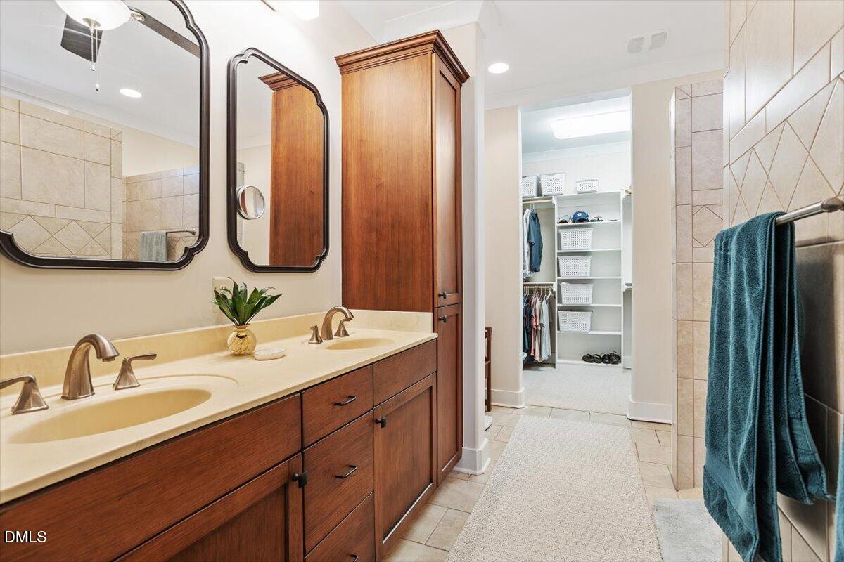31 River View Court Timberlake, NC 27583 - Photo 25 of 44 a spacious bathroom with a double vanity sink a mirror and a shower