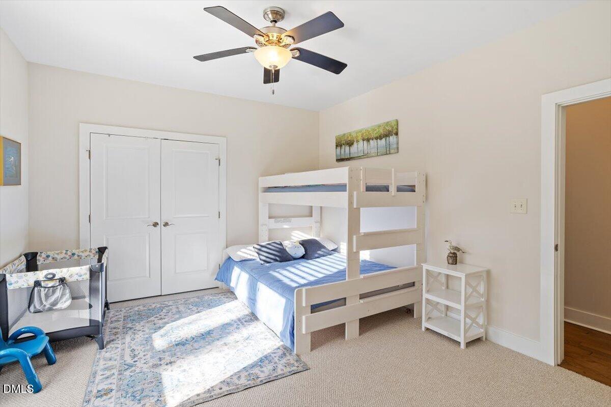 31 River View Court Timberlake, NC 27583 - Photo 29 of 44 a bedroom with a bed and a chandelier