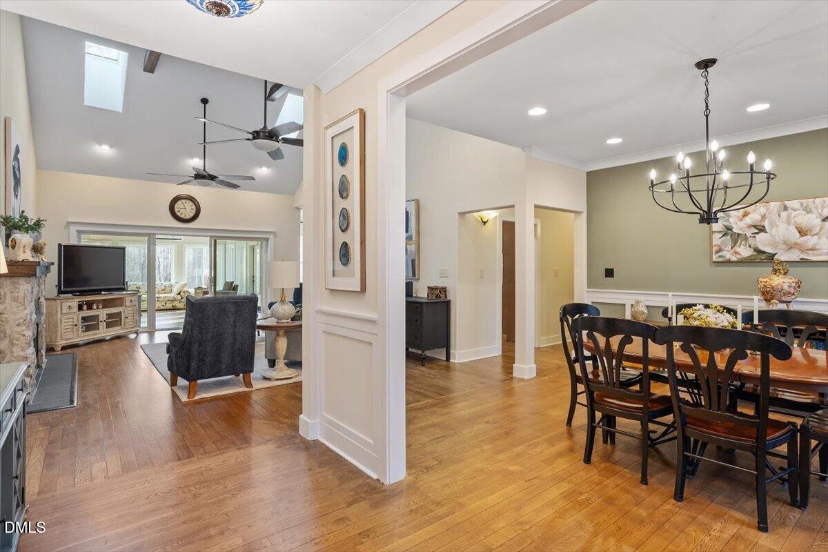 31 River View Court Timberlake, NC 27583 - Photo 6 of 44 a view of a dining room and livingroom with furniture wooden floor a chandelier