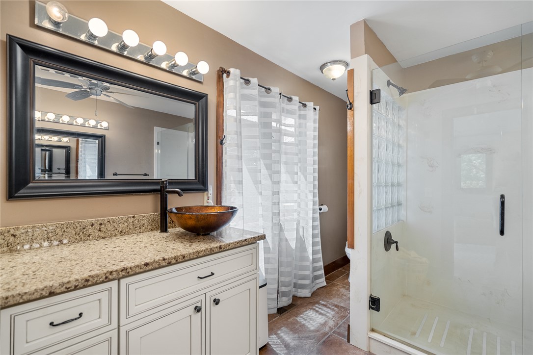 324 Hobson Road Anderson, SC 29621 - Photo 26 of 46 This bathroom features a contemporary vanity with a unique vessel sink and a spacious glass-enclosed shower.