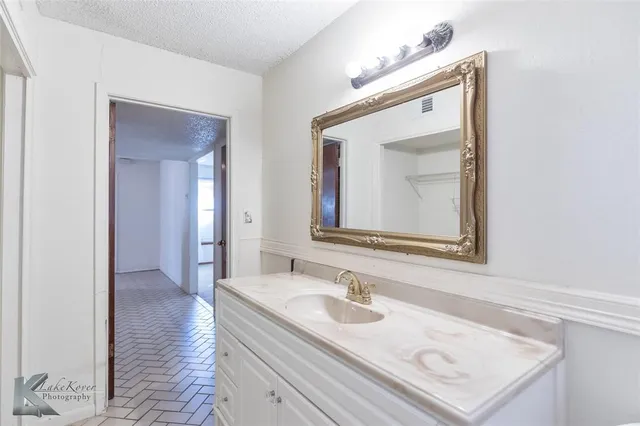 a en suite bathroom with a sink double vanity and mirror