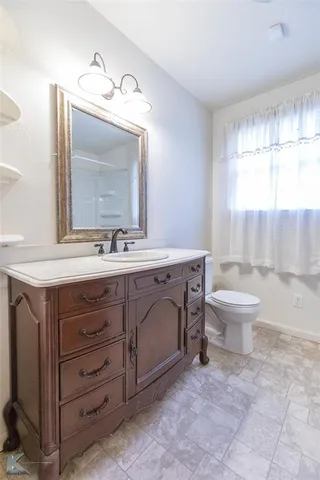 a bathroom with a sink toilet and a mirror