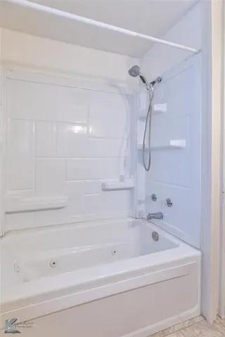a bathroom with a bathtub and shower