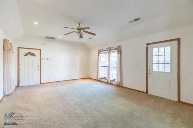 a view of an empty room with a window