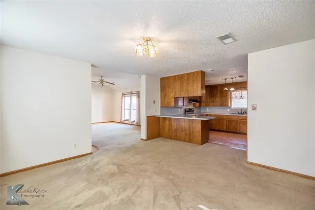 a large kitchen with a sink and cabinets