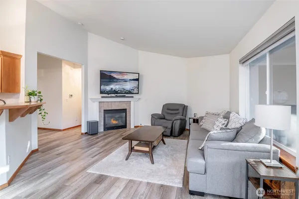a living room with furniture a fireplace and a window