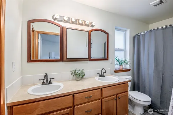 a bathroom with 2 sink and a mirror
