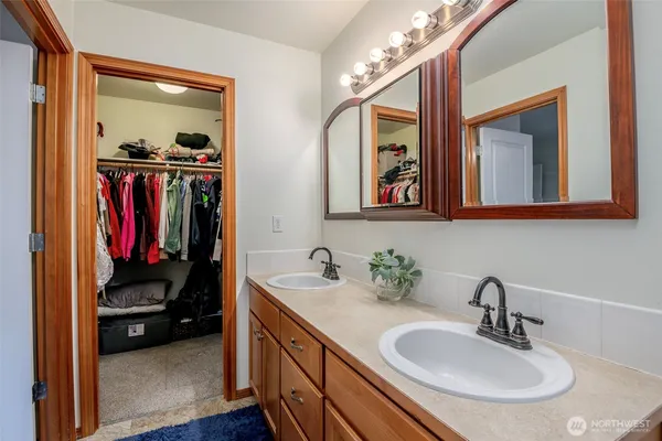 a en suite bathroom with a sink double vanity and a mirror