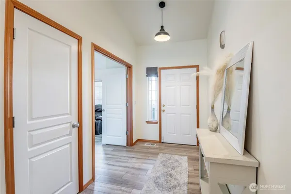 a view of an entryway with wooden floor