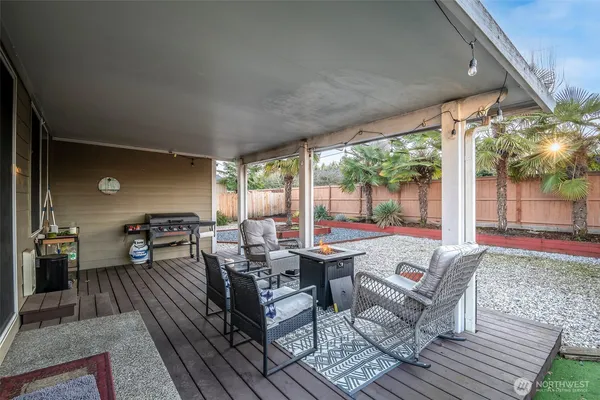 a living room with patio furniture and a floor to ceiling window