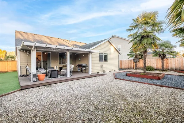 a view of a house with backyard porch and sitting area