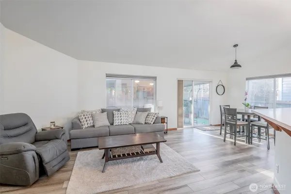 a living room with furniture wooden floor and a table