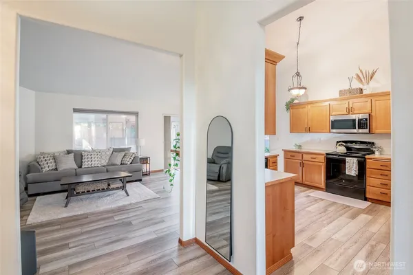 a living room with furniture and a kitchen view