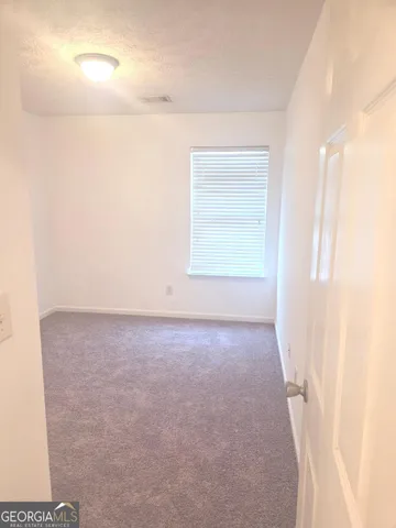 a view of an empty room and a window