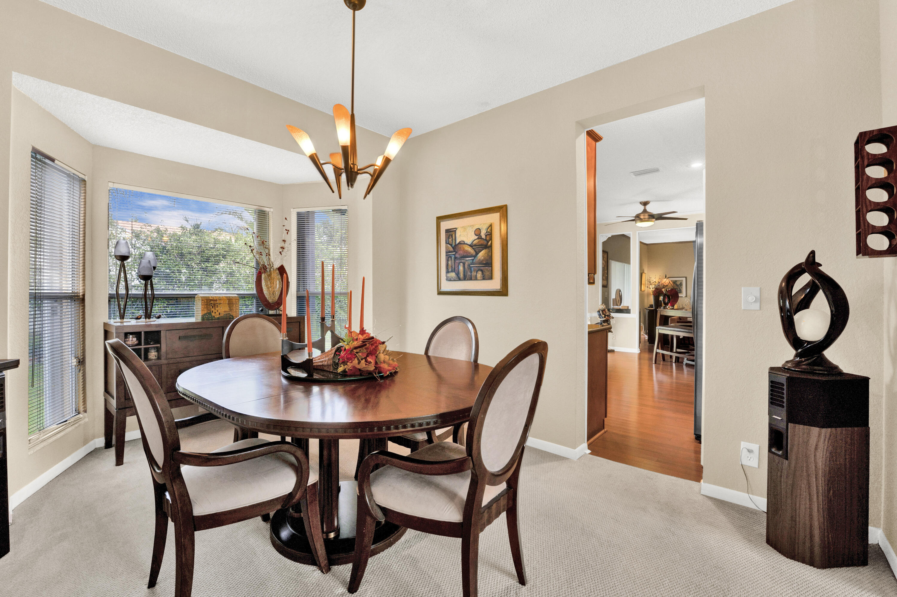 22211 Clocktower Way Boca Raton, FL 33428 - Photo 12 of 38 a dining room with furniture a chandelier and window
