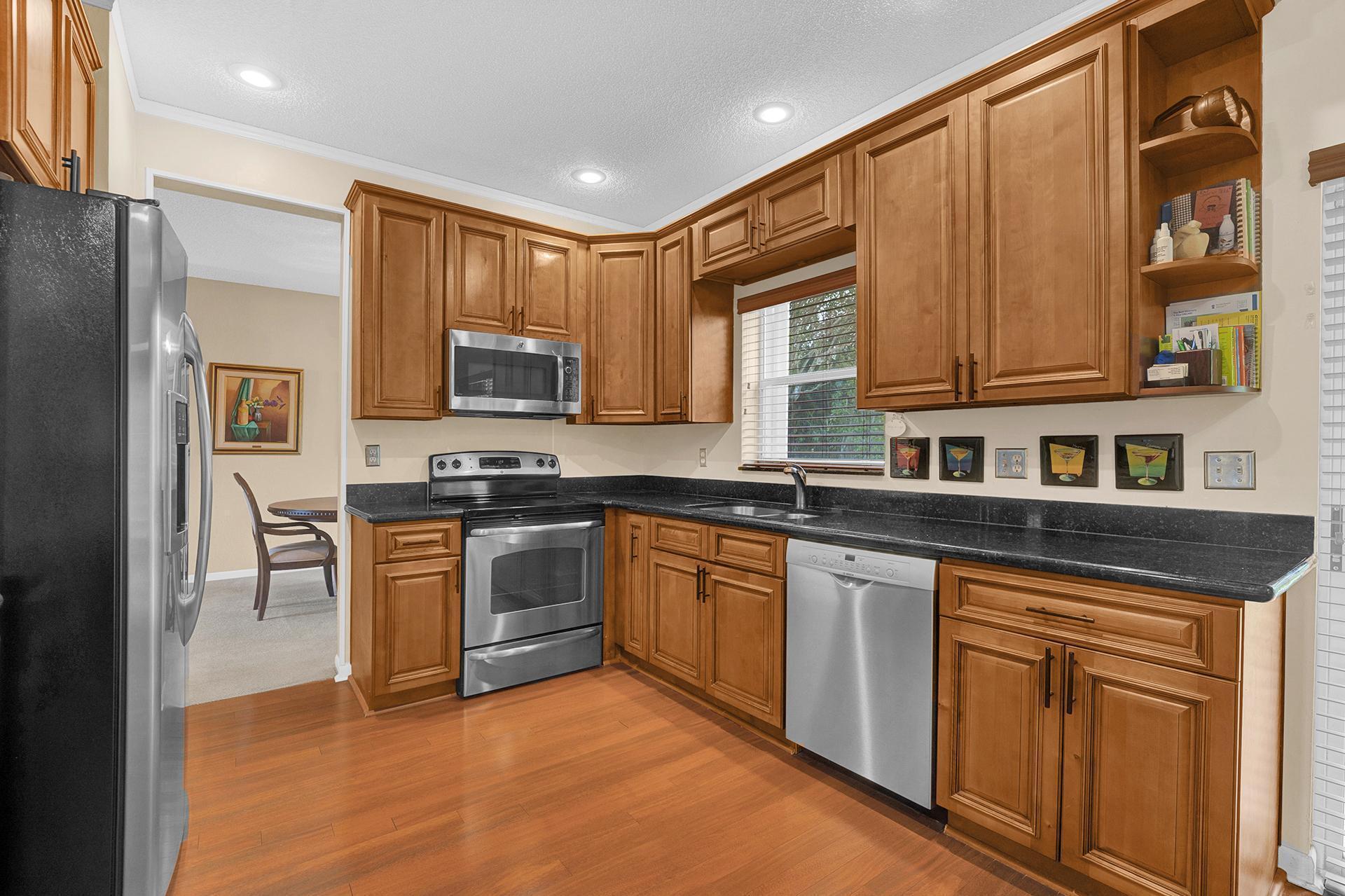 22211 Clocktower Way Boca Raton, FL 33428 - Photo 15 of 38 a kitchen with stainless steel appliances granite countertop a stove a sink dishwasher and a refrigerator