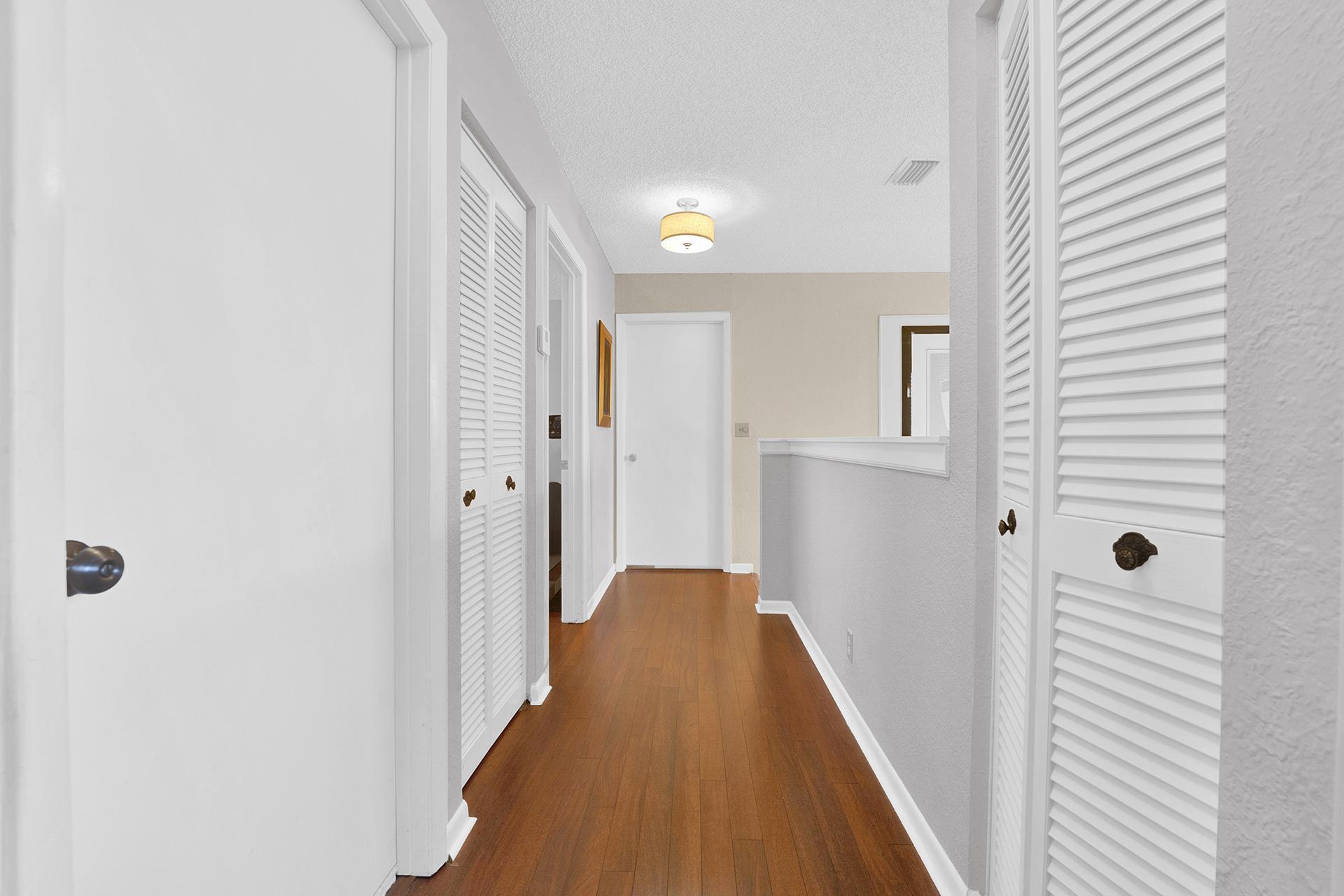 22211 Clocktower Way Boca Raton, FL 33428 - Photo 17 of 38 a view of a hallway with wooden floor and staircase