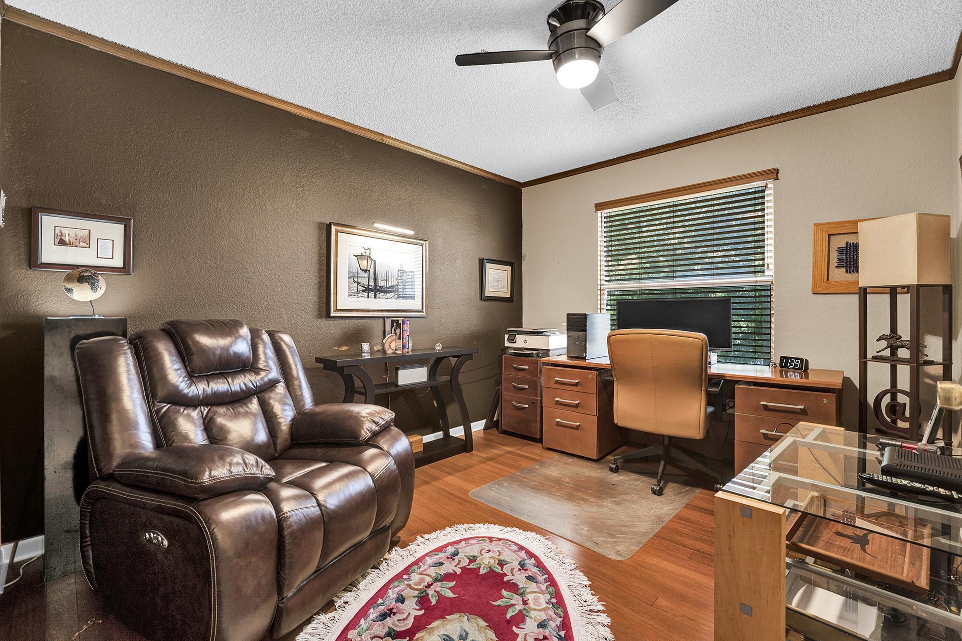 22211 Clocktower Way Boca Raton, FL 33428 - Photo 19 of 38 a living room with furniture two window and a flat screen tv