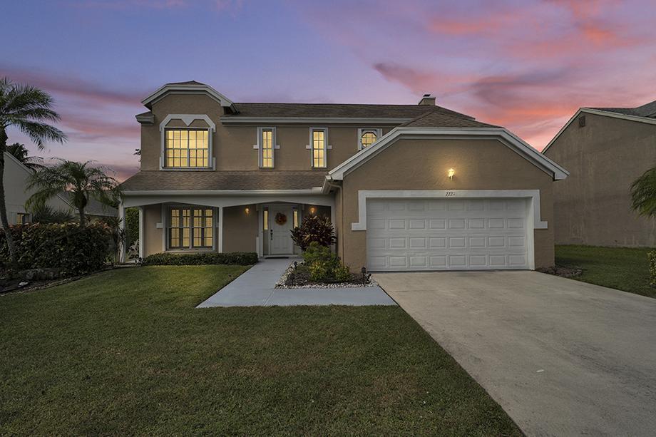 22211 Clocktower Way Boca Raton, FL 33428 - Photo 2 of 38 a front view of a house with a yard and garage