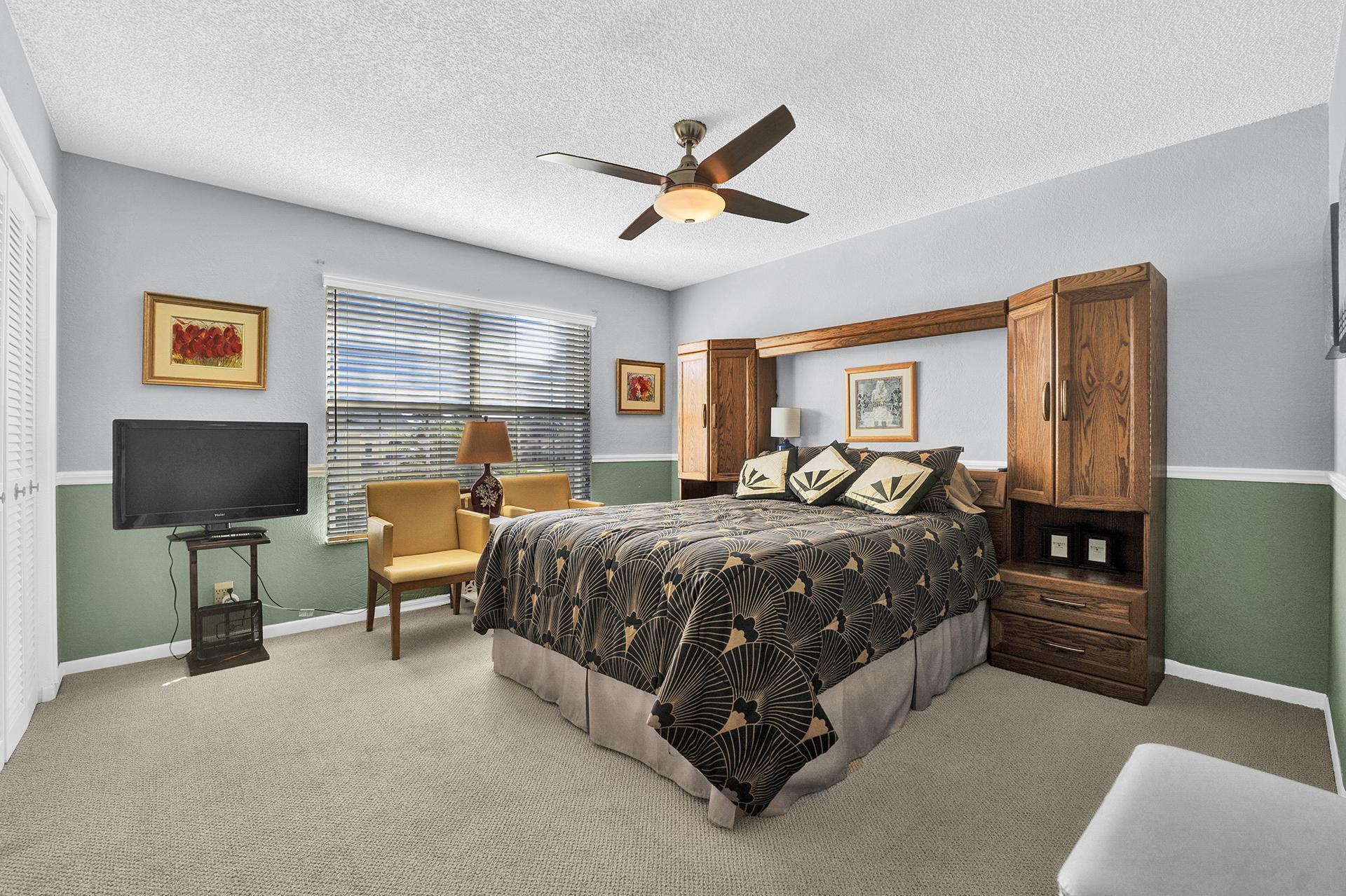 22211 Clocktower Way Boca Raton, FL 33428 - Photo 21 of 38 a bedroom with a bed and a flat screen tv