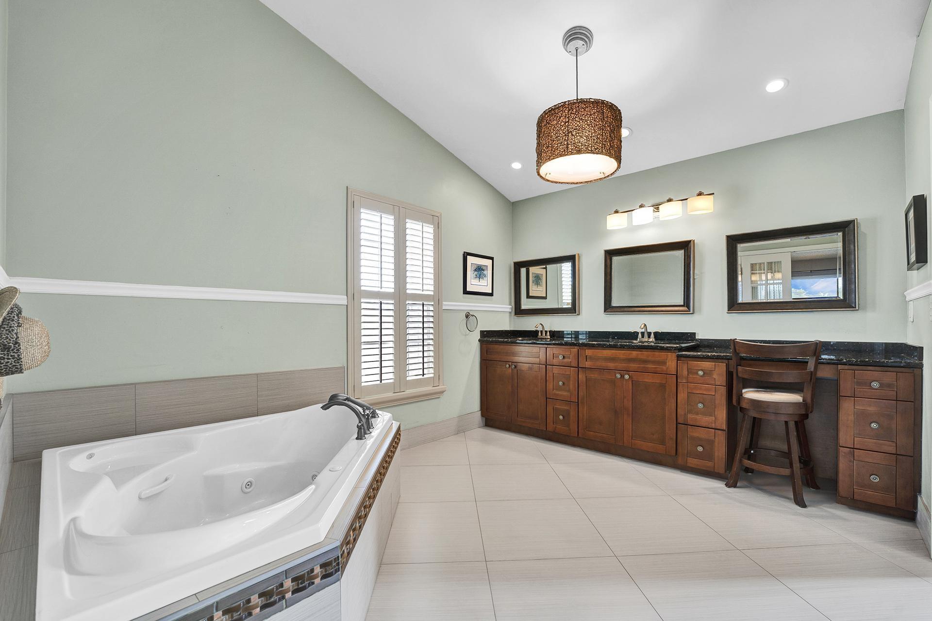 22211 Clocktower Way Boca Raton, FL 33428 - Photo 23 of 38 a spacious bathroom with a tub sink and mirror