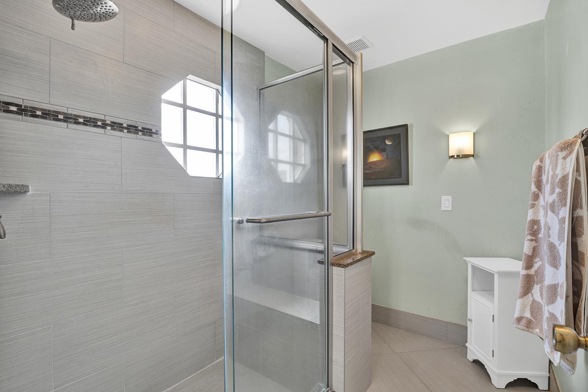 22211 Clocktower Way Boca Raton, FL 33428 - Photo 24 of 38 a bathroom with a glass shower door