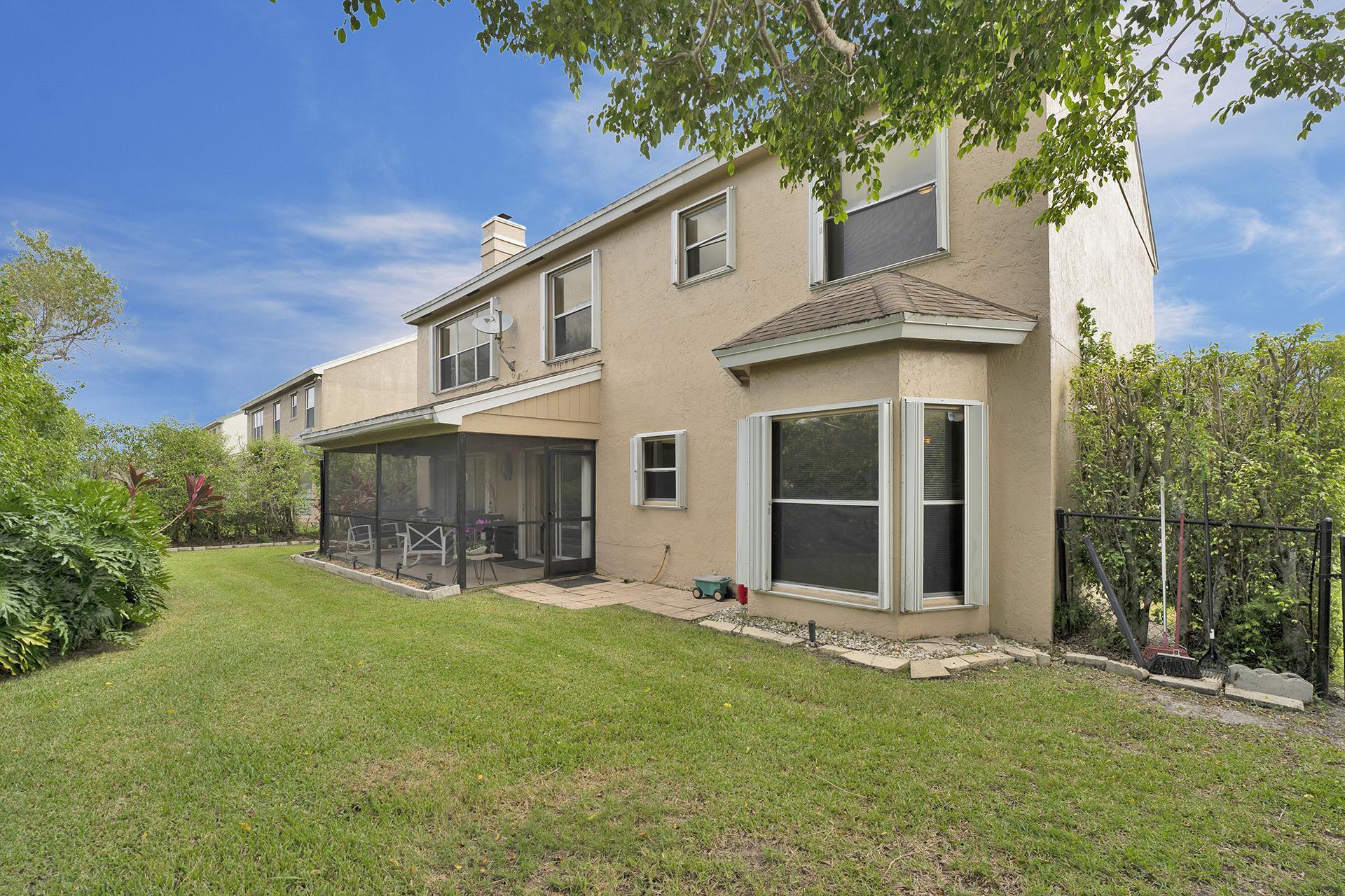 22211 Clocktower Way Boca Raton, FL 33428 - Photo 33 of 38 front view of a house with a yard
