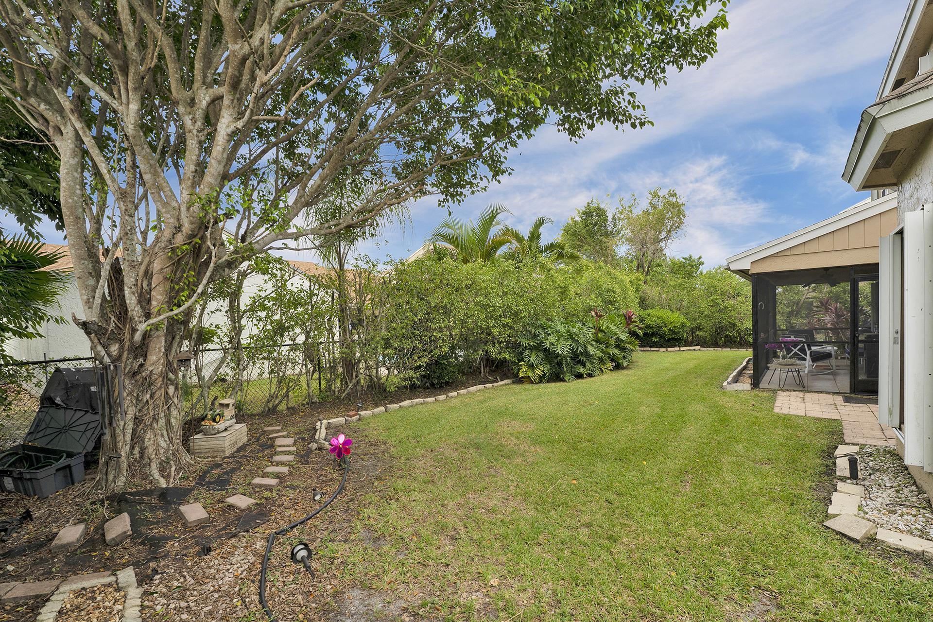 22211 Clocktower Way Boca Raton, FL 33428 - Photo 34 of 38 a backyard of a house with table and chairs
