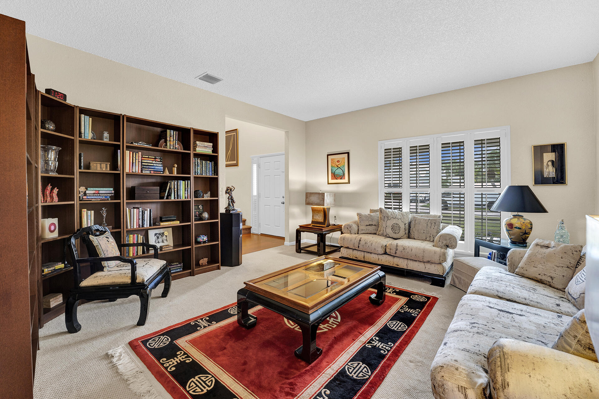 22211 Clocktower Way Boca Raton, FL 33428 - Photo 9 of 38 a living room with furniture and a book shelf