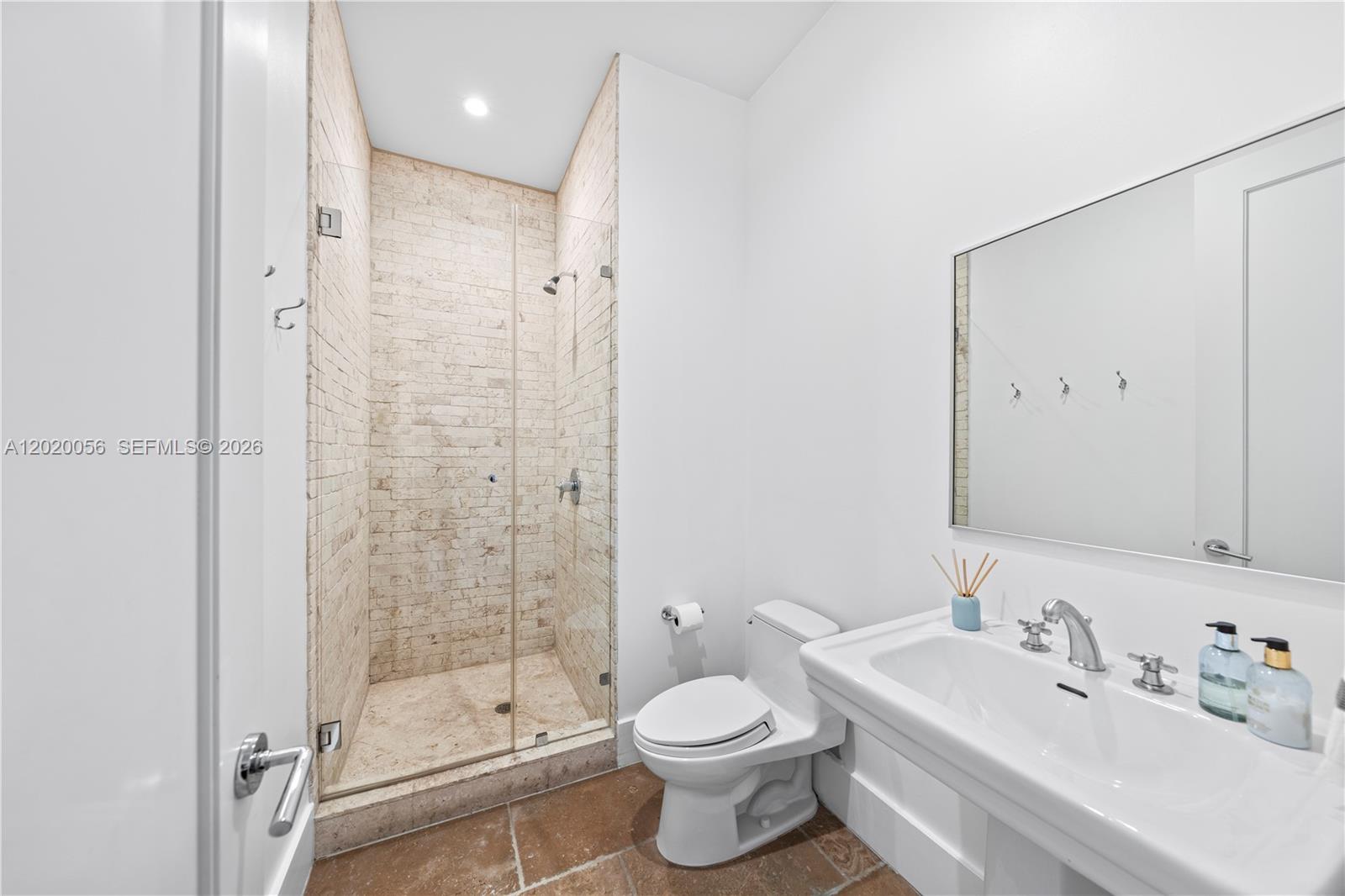 4196 Douglas Road Miami, FL 33133 - Photo 71 of 96 a bathroom with a toilet sink shower and mirror